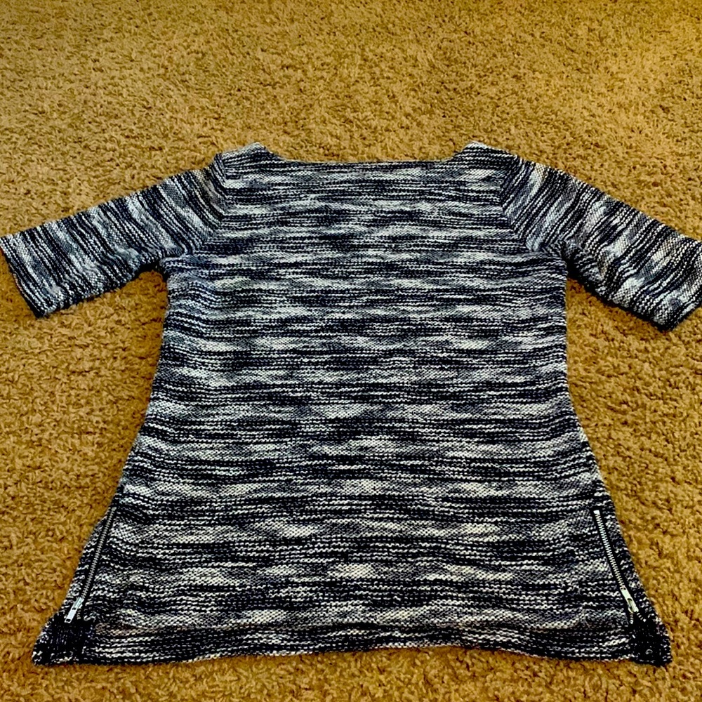 Navy and white short sleeve sweater with zipper detail on the sides.